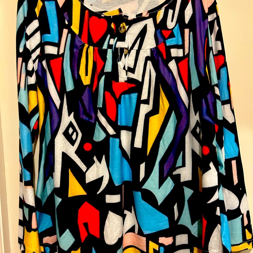 Multi color ladies long sleeve top with button.
